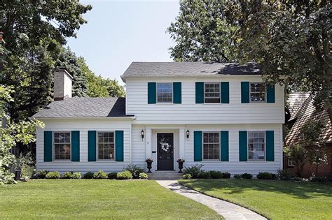 white house with white metal roofing green shutters|brown shutters on white house.